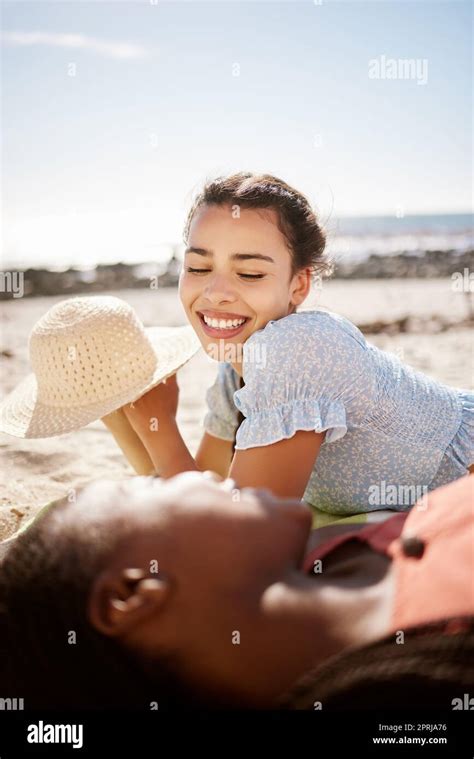 Summer Beach Fun And Female Friends Lying On The Sand While Talking Laughing And Relax On A