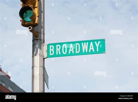 Broadway Street Sign With Green Traffic Light In New York City New