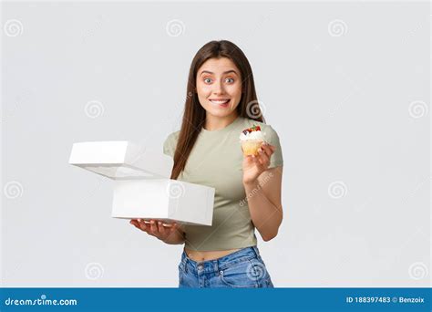 delivery lifestyle and food concept cheerful cute woman open box order from pastry shop and