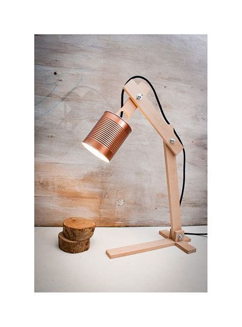 A Wooden Table Lamp With A Metal Shade On It And A Piece Of Wood Next To It