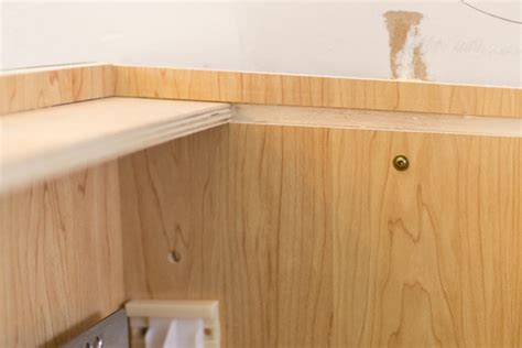 Next, tackle the sink cabinet, which is often the toughest cabinet to install. How to Install Kitchen Cabinets Yourself - Cherished Bliss
