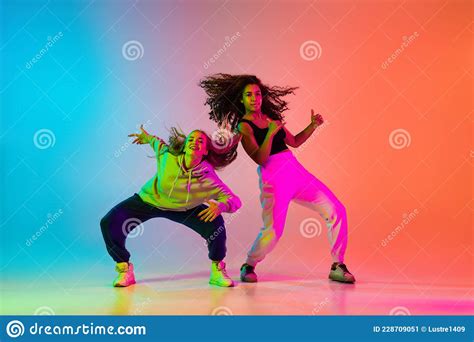 Two Beautiful Stylish Hip Hop Dancers On Colorful Gradient Background