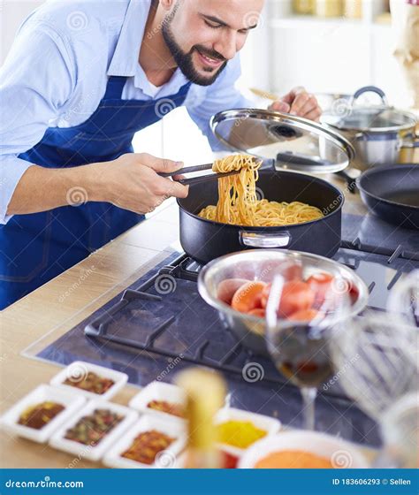 Man Preparing Delicious And Healthy Food In The Home Kitchen Stock