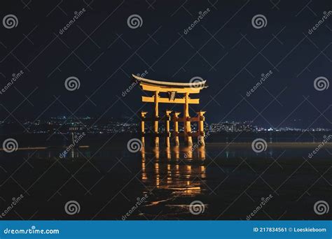 The Floating Torii Gate Of Itsukushima Shrine Illuminated In The Night