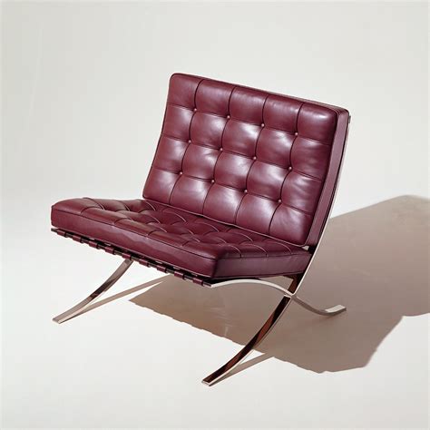 A Red Leather Chair Sitting On Top Of A Metal Frame Flooring Next To A