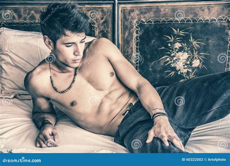 Shirtless Male Model Lying Alone On His Bed Stock Photo Image Of Model Macho