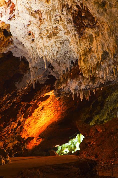 The Inside Of A Cave With Light Coming From It