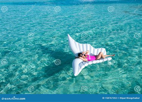 Luxury Summer Vacation Beach Woman Relaxing Lying Down On Inflatable