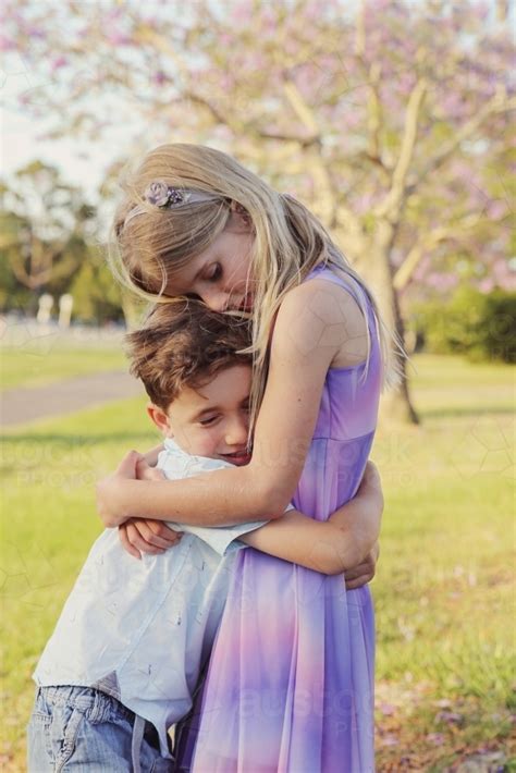 Image Of Happy Brother Hugs Big Sister In The Park Austockphoto