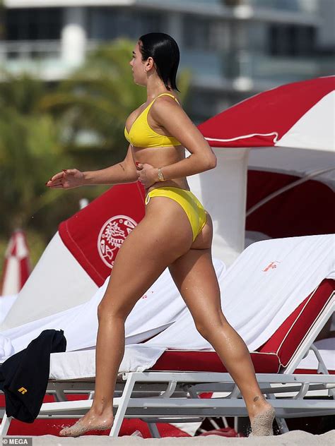 Dua Lipa Showcases Her Slender Figure In A Yellow Bikini For Beach Date