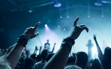 Fans Raising Their Hands Up At Live Concert By Stocksy Contributor