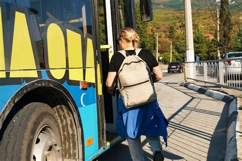 Premium Photo Young Girl Tourist Enters Bus