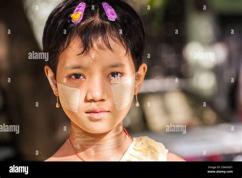 Beautiful Young Burmese Girl With Thanaka On Face Poses For Photo