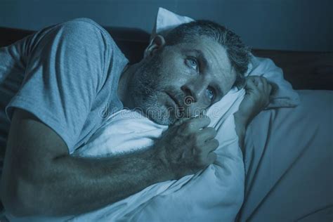 Dramatic Portrait In The Dark Of Attractive Depressed And Worried Man