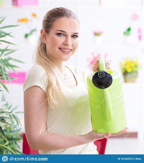 Young Woman Watering Plants In Her Garden Stock Photo Image Of