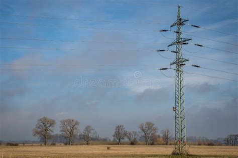 High Voltage Power Lines Through Fields And Meadows They Supply Power
