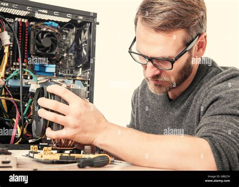 Computer Repair Technician Installs Accessories Of Computer Stock