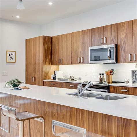 Walnut cabinets and dark countertops this stately kitchen stands dark wood furniture over light orange tile flooring, with large dining table featuring lazy susan up … Gorgeous walnut kitchen cabinets with white counter and ...