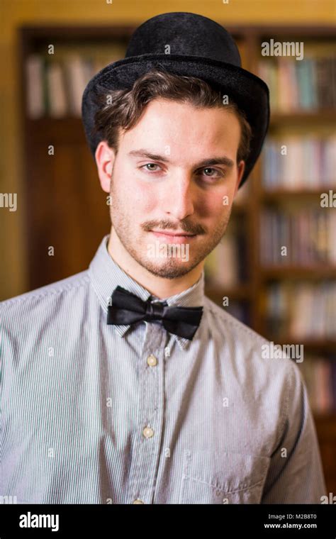 Attractive Young Man Wearing Top Hat And Bow Tie Stock Photo Alamy