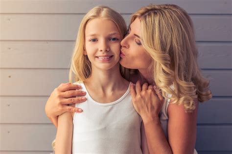 premium photo attractive blonde teenage girl and her mother hugging