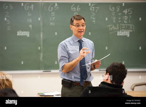 Teacher Explaining To Students In Front Of A Chalkboard Stock Photo Alamy