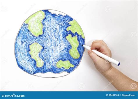 Child`s Hand Drawing Planet Earth With A Marker Stock Photo Image Of