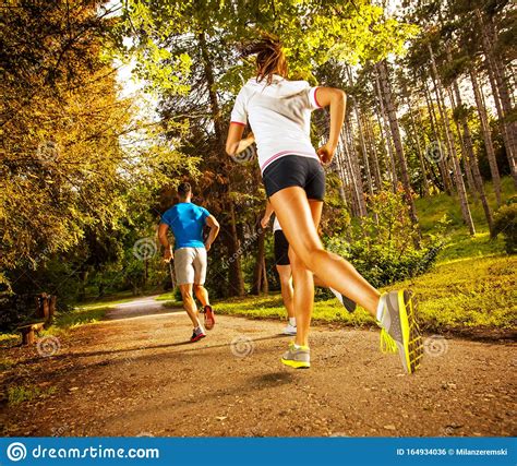 Group Of Young Runners Running In Nature Stock Photo Image Of Action