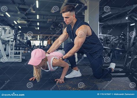 Fitness Instructor Help Girl To Do Push Ups On Training In Fitness
