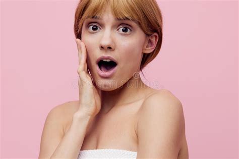 A Close Horizontal Beauty Photo On A Pink Background Of A Surprised Woman With Her Hair Pinned