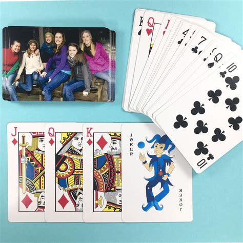 Four Playing Cards With Pictures Of People On Them And One Holding A
