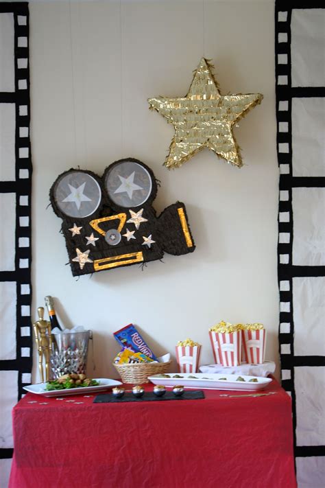 Oscar Party Buffet With Film Strips And Movie Themed Piñatas