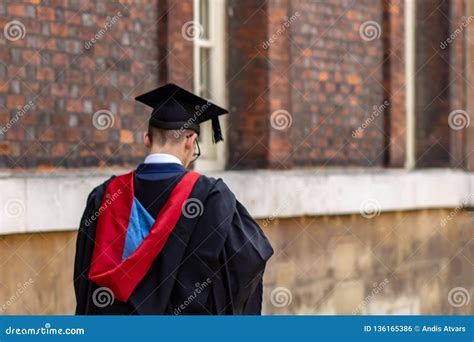 Graduate Man Student Wearing Graduation Hat And Gown At University Camp
