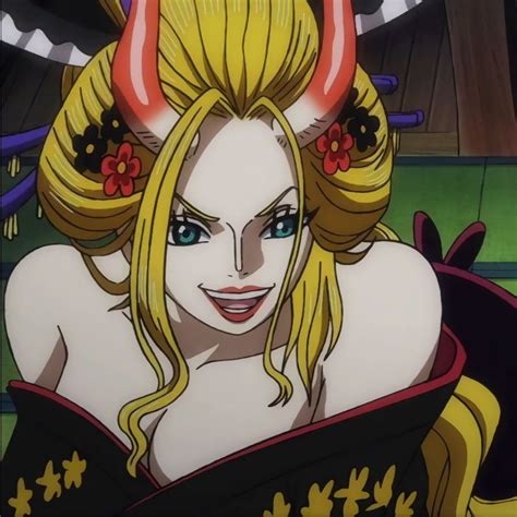 A Woman With Blonde Hair And Horns On Her Head Is Looking At The Camera While Sitting Down