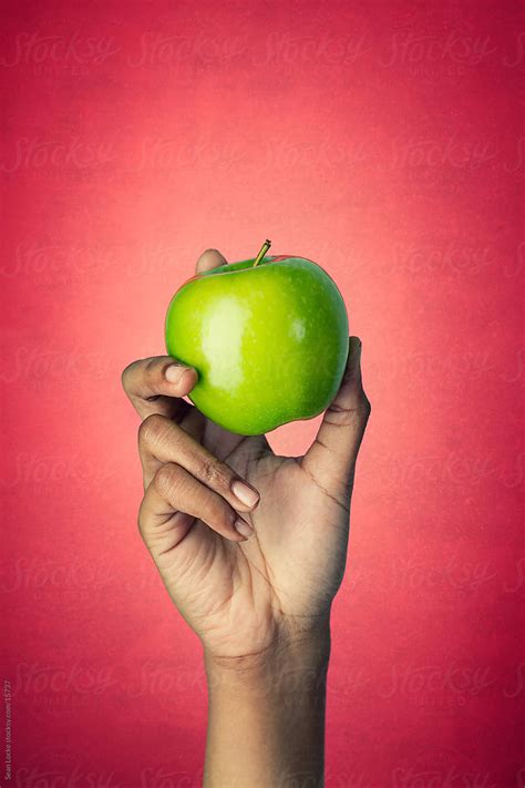 Healthy Woman Holds Whole Granny Smith Apple By Sean Locke