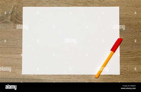 Blank White Paper Sheet With Red Pen On Wooden Desk Mockup Template