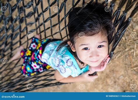 Cheerful Child Enjoying And Relaxing In Hammock Outdoor On Summer Day