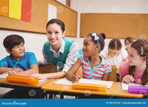 Teacher Helping Pupils During Class Stock Photo Image Of Classroom