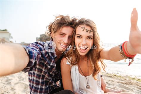 Cheerful Young Couple Taking Selfie On The Beach Royalty Free Stock Image Storyblocks