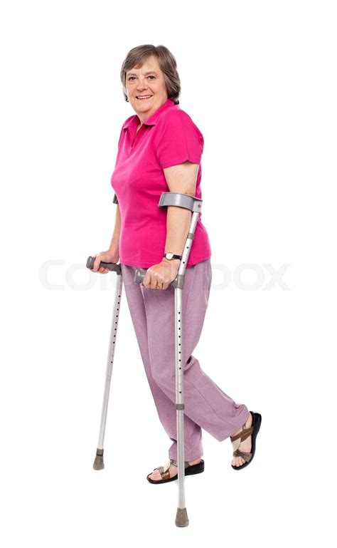 Smiling Senior Woman Walking With Crutches Stock Image Colourbox