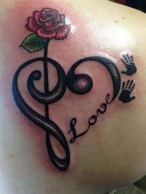 The artwork speaks for itself. Musical themed heart tattoo with a pretty red rose on top ...