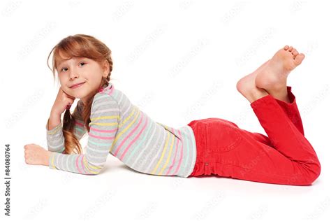 Foto De Side View Of Smiling Child Girl Lying On Stomach Do Stock