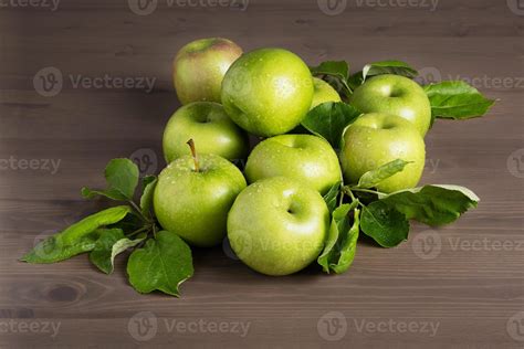 Fresh Ripe Green Apples And Apple Tree Leaves On A Wooden Background