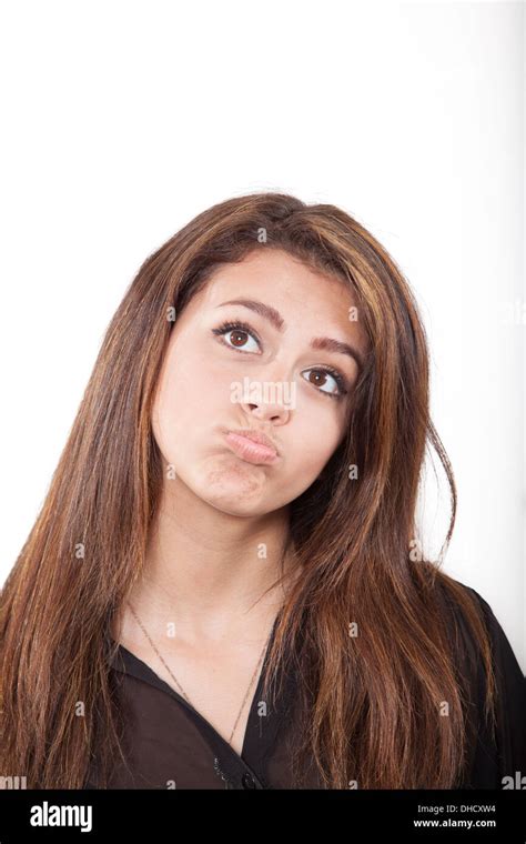 Mixed Race Teen Girl Pursing Lips And Thinking Pondering Stock Photo