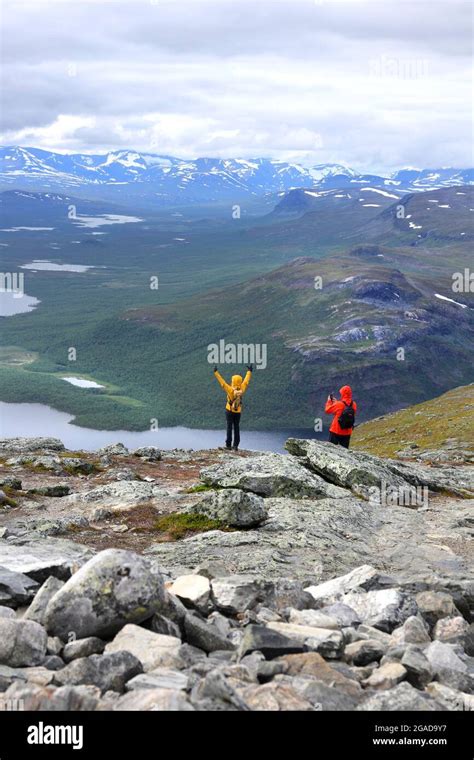 Two Backpack Hikers High On Saana Fell Mountain Top In Finnish Lapland