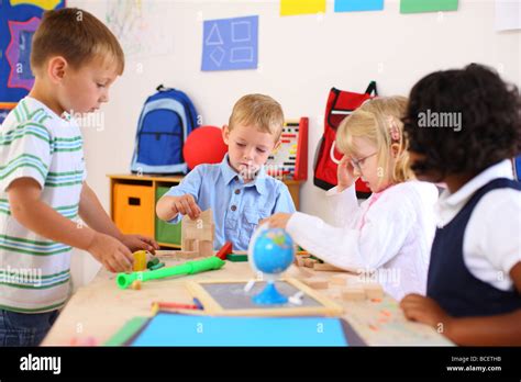 Four Kids Playing In Preschool Classroom Stock Photo Alamy