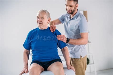 Portrait Of Massage Therapist Massaging Neck Of Young Woman Stock Image