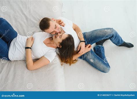 Selective Focus Of Two People In Love Hugging While Sitting In Bed