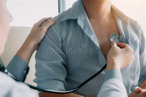 Asian Doctor Is Using A Stethoscope Listen To The Heartbeat Of The