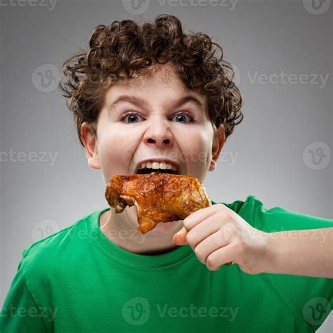Boy Eating Chicken Leg 1420431 Stock Photo At Vecteezy