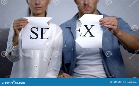 couple tearing into pieces sex word on cardboard sexual life disorder problems stock image